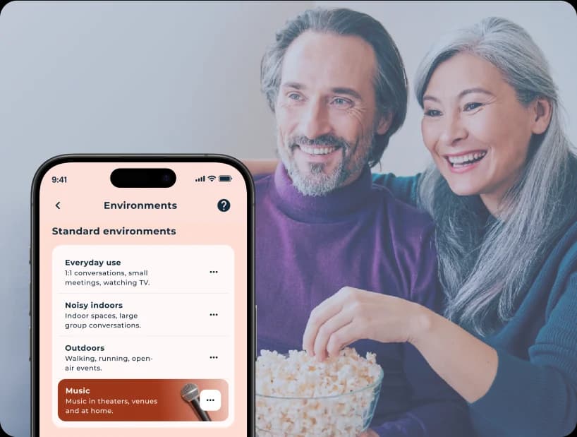 Man and woman watching TV and eating popcorn. 