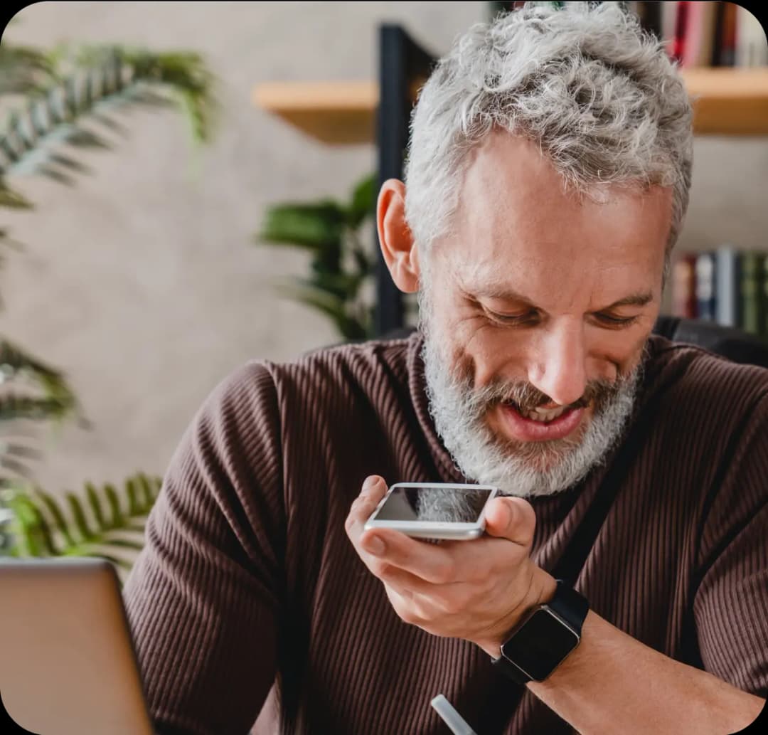 Man using phone for hearing support.